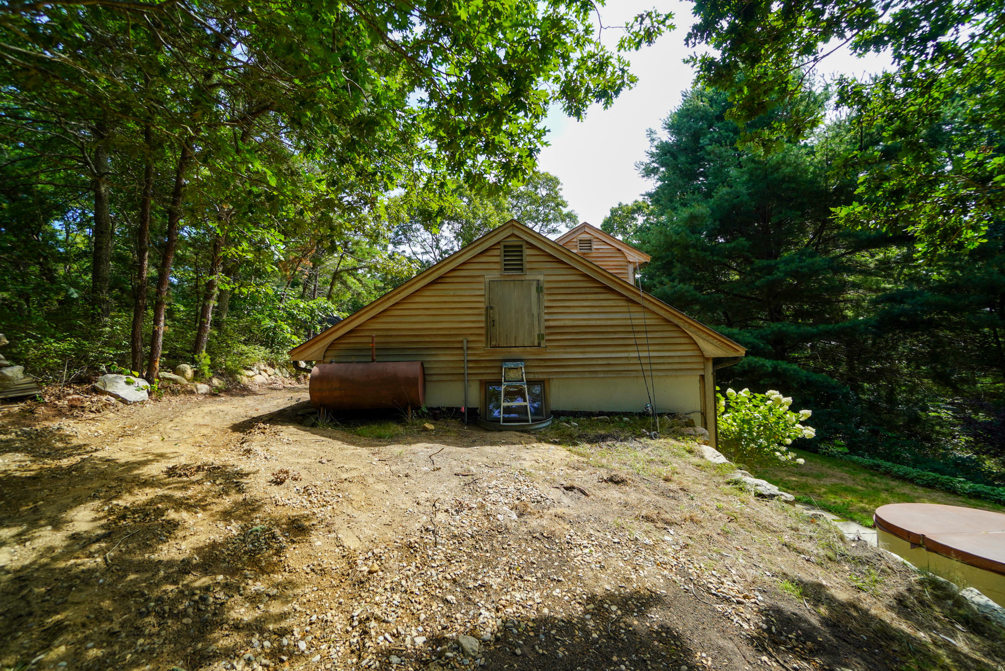 92 Springhill Road Vineyard Haven, MA 02568 - Photo 10 of 38 a house covered with tall trees