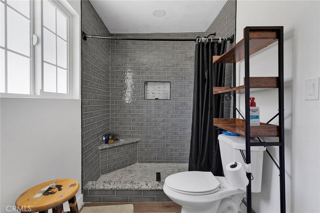 15471 Washoan Road Apple Valley, CA 92307 - Photo 25 of 38 a bathroom with a toilet and a shower