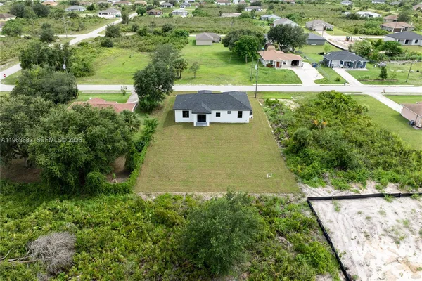 an aerial view of residential houses with outdoor space and street view