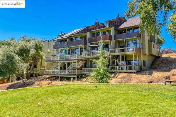 a front view of a building with a garden