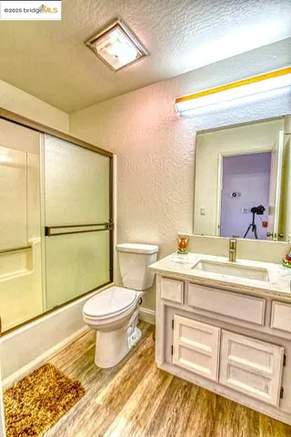 a bedroom with a bed and a dresser next to a window