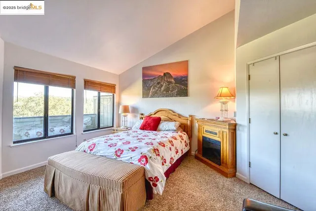 a bedroom with a bed and a large window