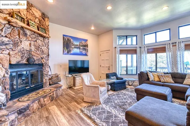 a living room with furniture large window and a fireplace