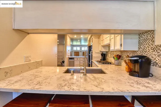a view of a dining room with furniture a chandelier and wooden floor