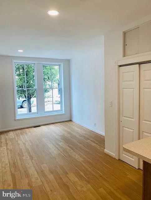 407 South 20th Street, Unit A Philadelphia, PA 19146 - Photo 4 of 14 an empty room with wooden floor and windows