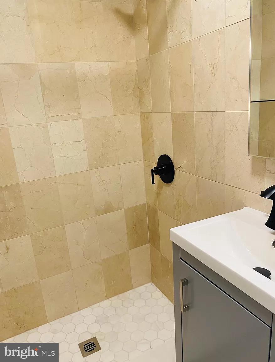 407 South 20th Street, Unit A Philadelphia, PA 19146 - Photo 5 of 14 a bathroom with a sink a toilet and shower