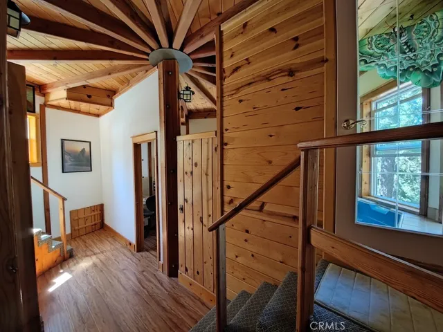 a view of an entryway with wooden floor and door