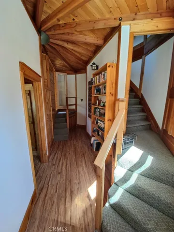 a view of entryway with wooden floor and stairs