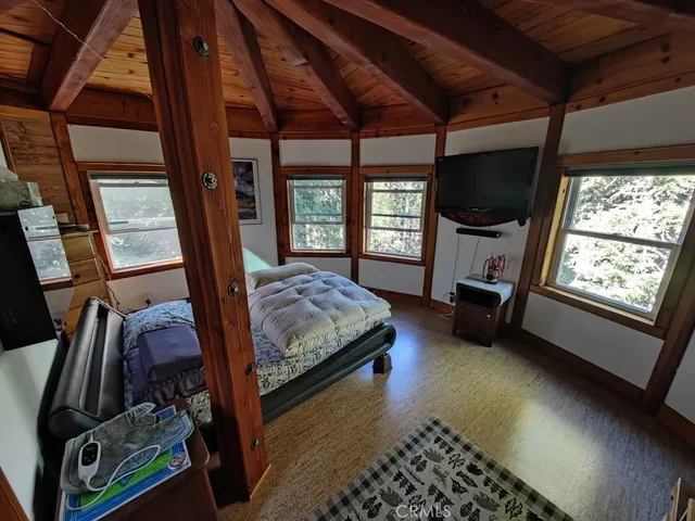 a spacious bedroom with a bed and a window