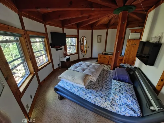 a bed sitting in a bedroom next to a window