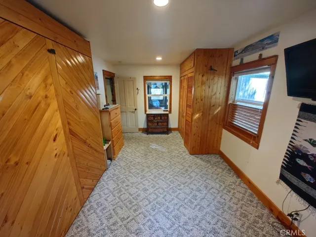 a view of hallway with stairs and wooden floor