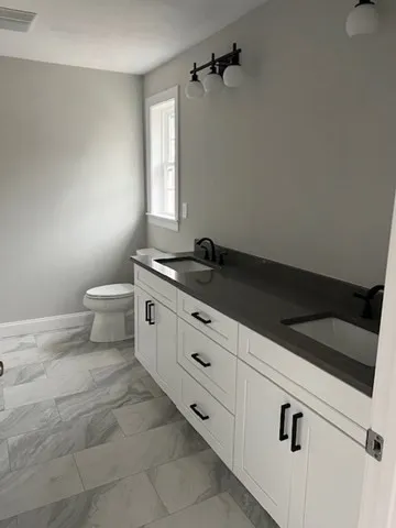 a bathroom with a toilet and a shower