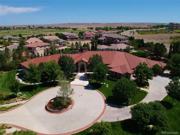 an aerial view of a residential houses with outdoor space and river