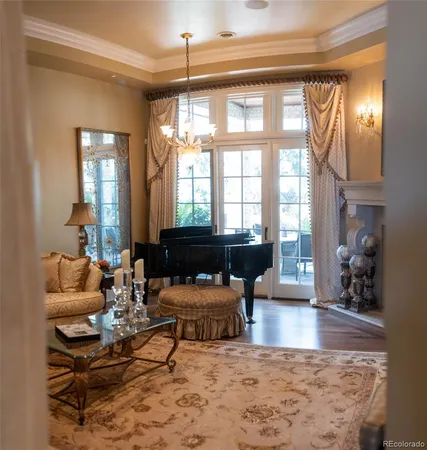 a living room with furniture and a chandelier