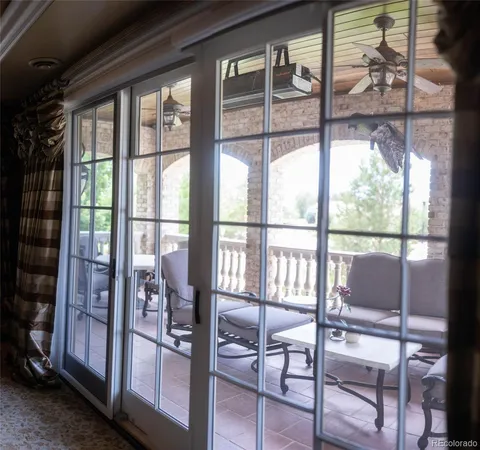 a view of a room with a floor to ceiling window and wooden floor