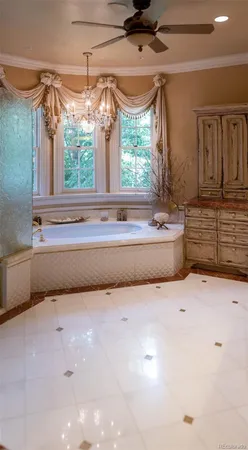 a bathroom with a tub sink and mirror