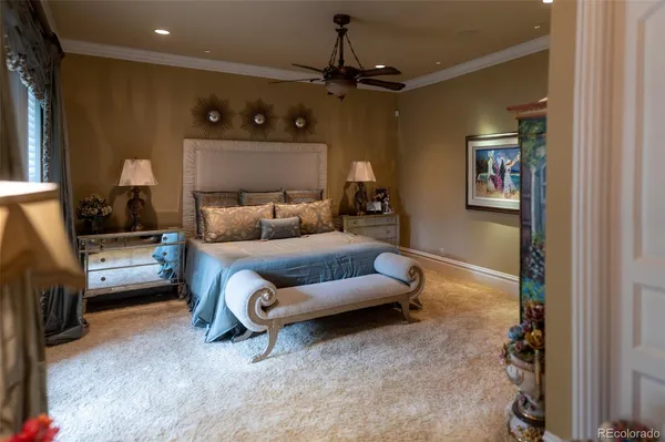 a living room with furniture and a ceiling fan