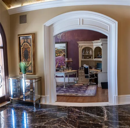 a living room with fireplace furniture and wooden floor