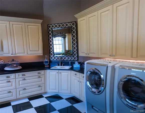 a utility room with sink dryer and washer
