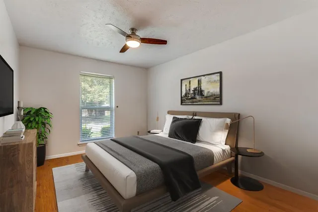 a bedroom with a large bed and a chandelier