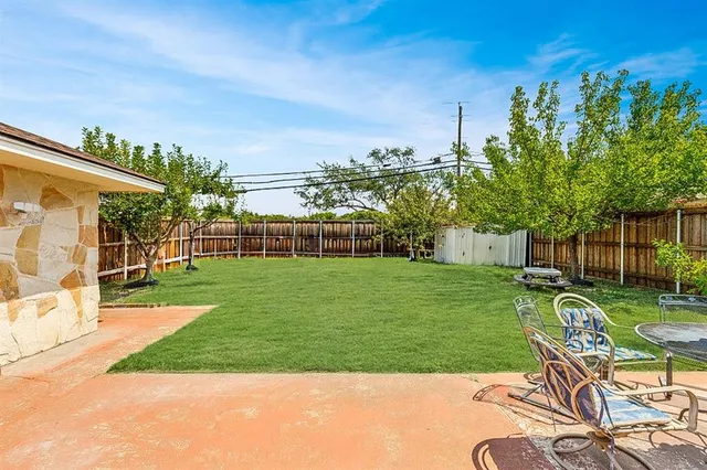 a view of a chair and table on the garden