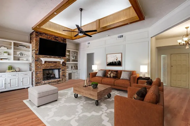 a living room with furniture a fireplace and a flat screen tv
