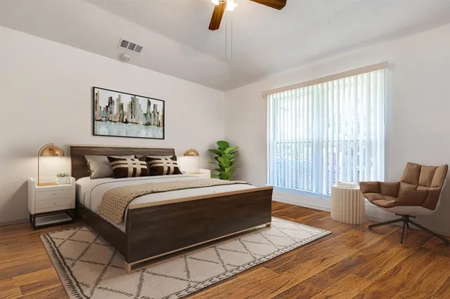 a spacious bedroom with a bed a couch and a window