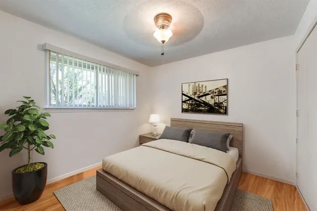 a bedroom with a bed and a potted plant