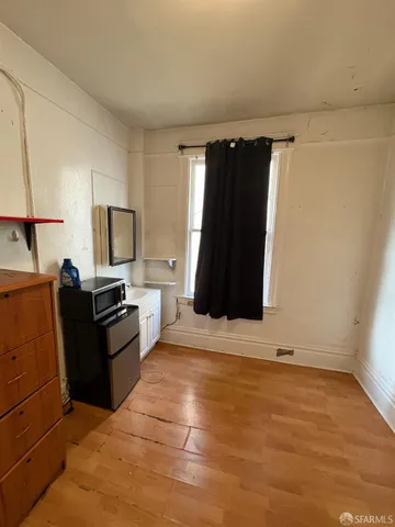a view of a livingroom with wooden floor
