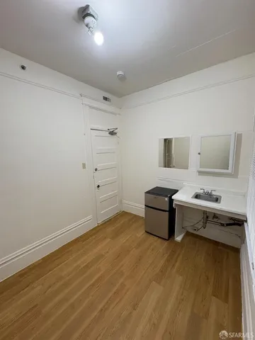 a room with a dresser and a wooden floor