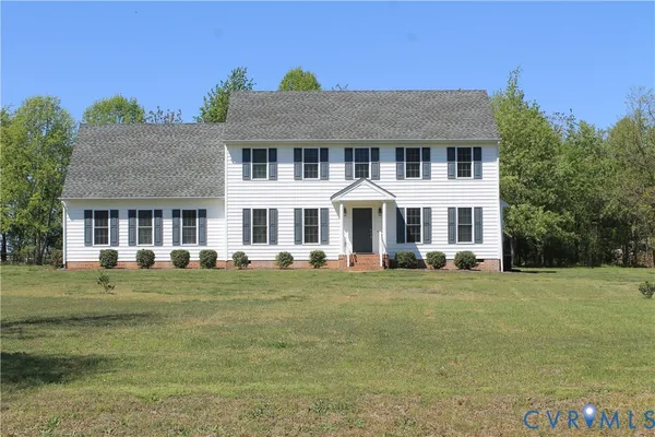 a front view of a building with a garden