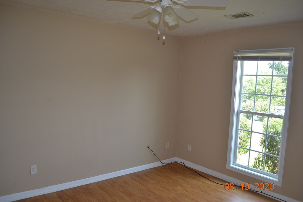 12a Crosswinds Road Phenix City, AL 36869 - Photo 20 of 21 an empty room with wooden floor fan and windows