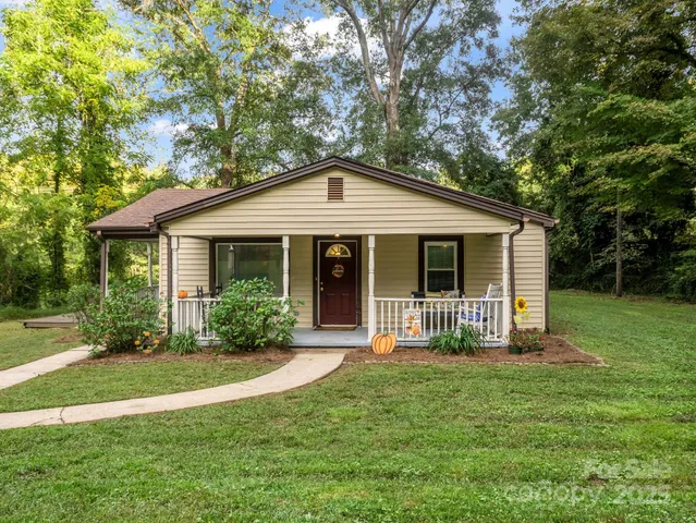 a front view of a house with a yard and porch