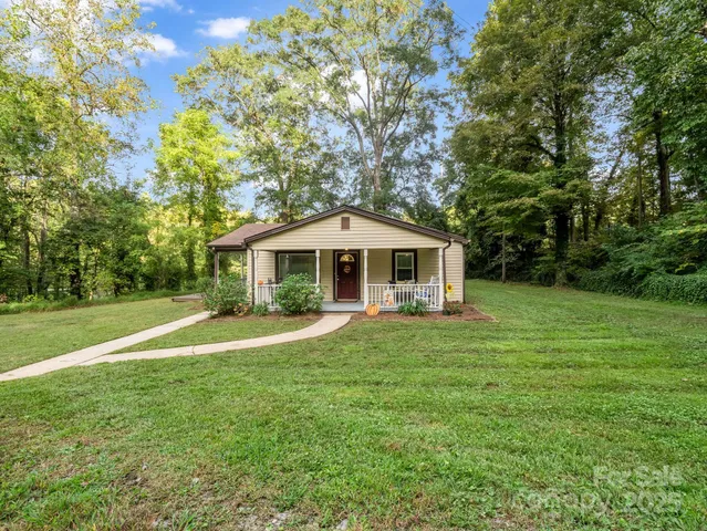 a front view of a house with yard and green space