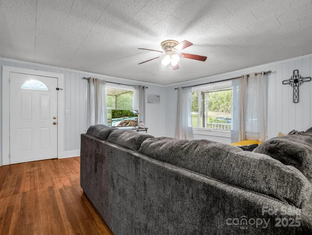 a living room with a bed furniture and a window