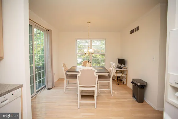 a dining room with furniture window outside view and wooden floor