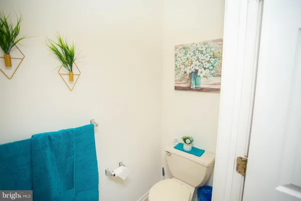 a white toilet sitting next to a bathroom sink