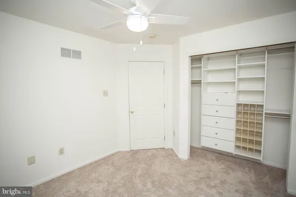 an empty room with furniture and closet