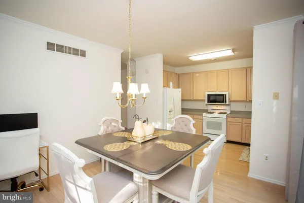 a kitchen with kitchen island a stove a table and chairs in it