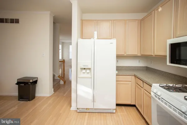 a kitchen with a refrigerator sink and cabinets