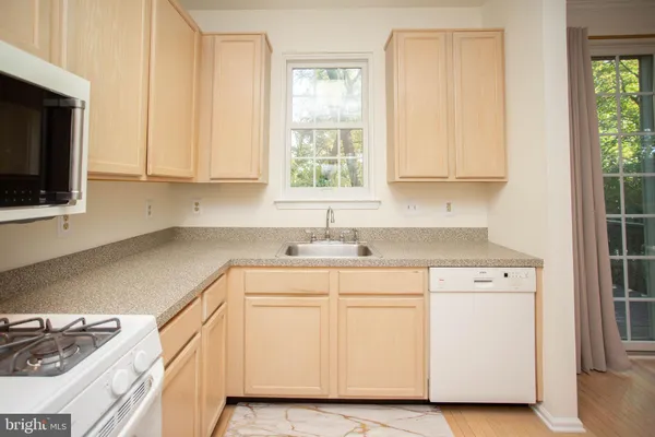 a kitchen with appliances cabinets and a sink