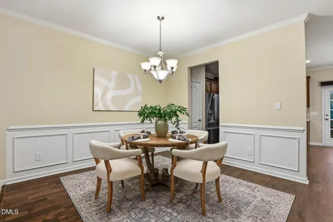 a dining room with furniture and chandelier