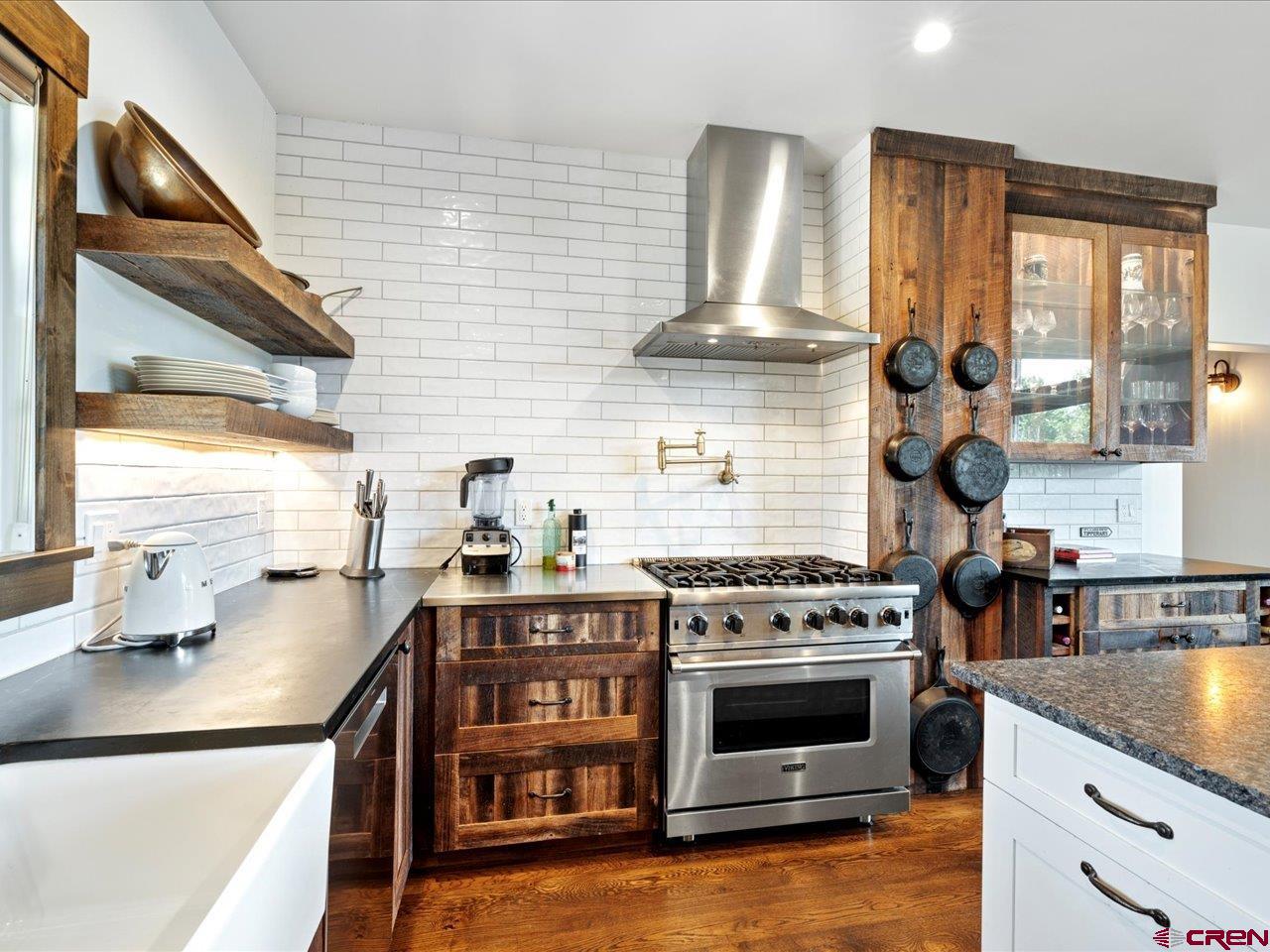 810 Pine Drive Ridgway, CO 81432 - Photo 15 of 36 a kitchen with stainless steel appliances granite countertop a stove and a sink