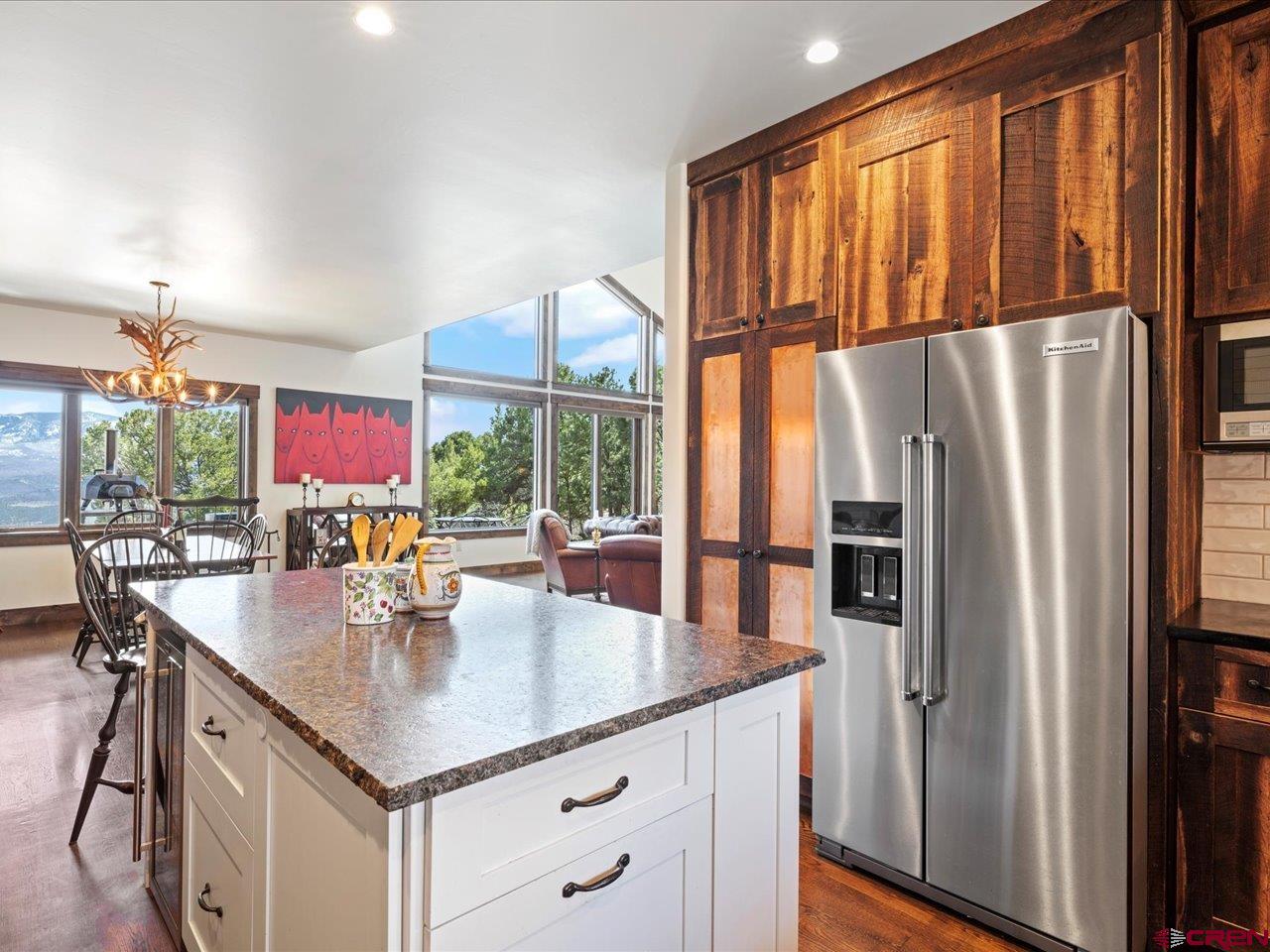 810 Pine Drive Ridgway, CO 81432 - Photo 16 of 36 a kitchen with stainless steel appliances granite countertop a refrigerator a stove and a kitchen island