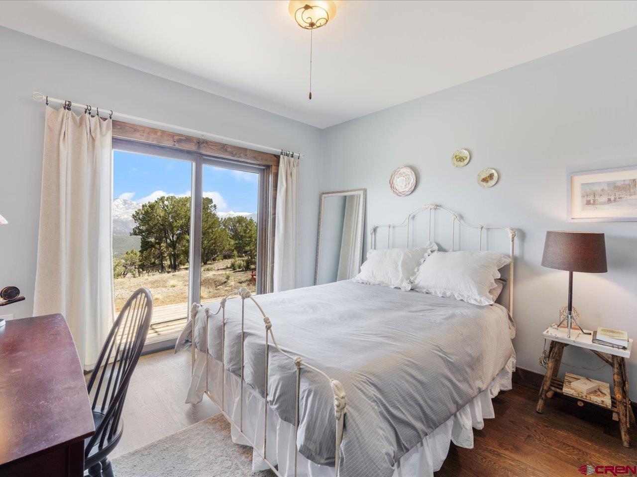 810 Pine Drive Ridgway, CO 81432 - Photo 18 of 36 a bedroom with a bed and a large window