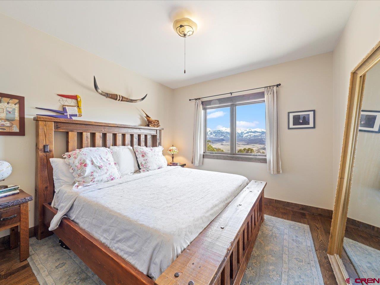 810 Pine Drive Ridgway, CO 81432 - Photo 20 of 36 a bedroom with a large bed and a window