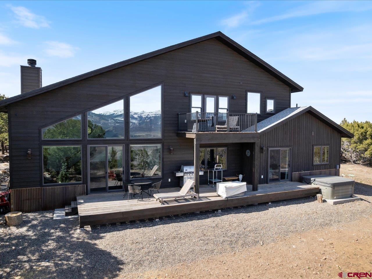810 Pine Drive Ridgway, CO 81432 - Photo 34 of 36 a view of a patio with table and chairs potted plants and floor to ceiling window