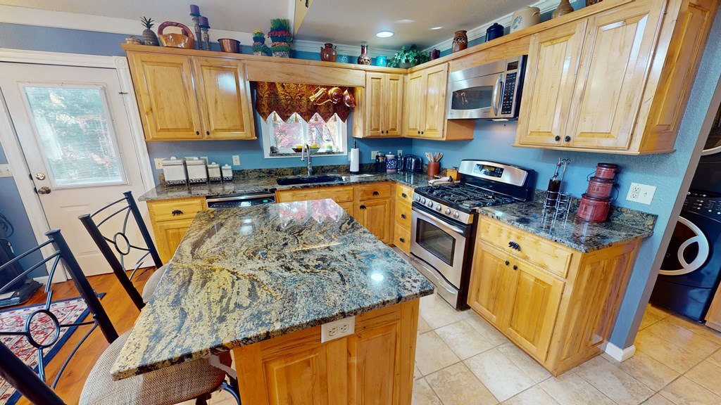 52 Bear Track Road Andrews, NC 28901 - Photo 16 of 38 a kitchen with stainless steel appliances granite countertop a stove a sink and a microwave