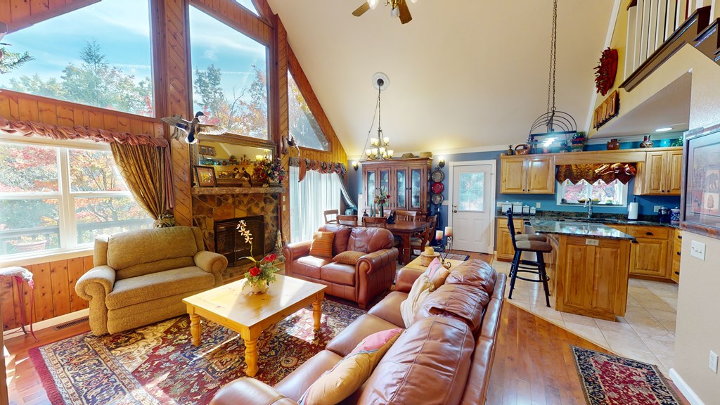 52 Bear Track Road Andrews, NC 28901 - Photo 18 of 38 a living room with furniture a fireplace and a floor to ceiling window