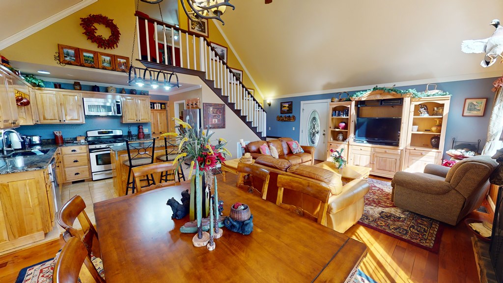 52 Bear Track Road Andrews, NC 28901 - Photo 21 of 38 a living room with patio furniture and a flat screen tv
